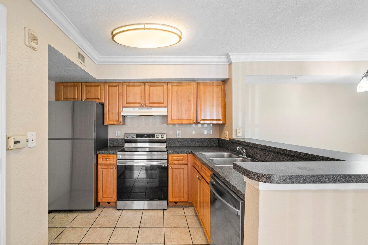 a kitchen with a stove a sink and a refrigerator