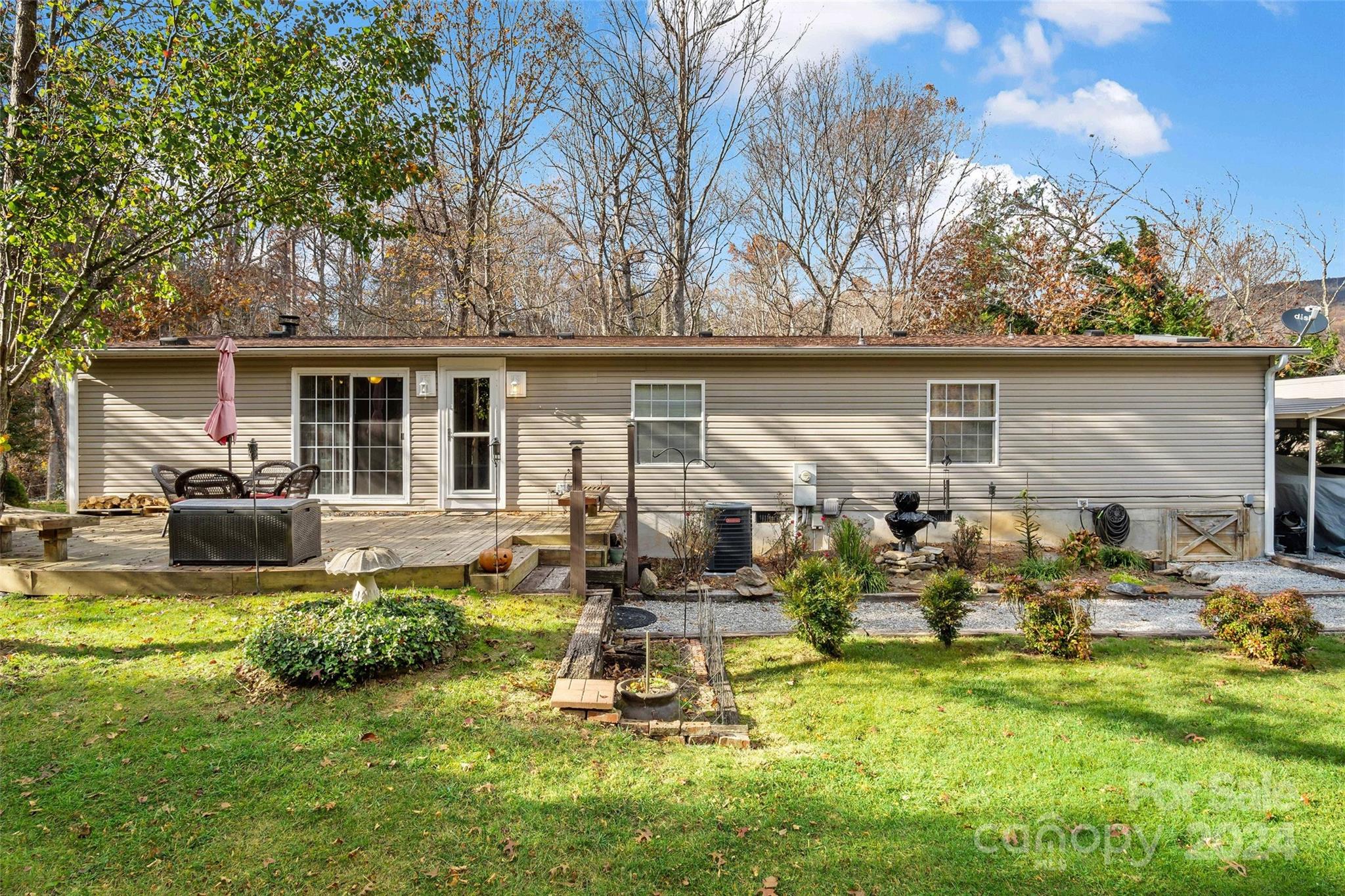 a view of a house with backyard outdoor seating area and furniture