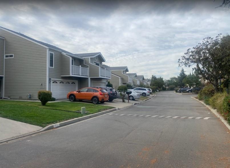 a couple of cars parked in front of house