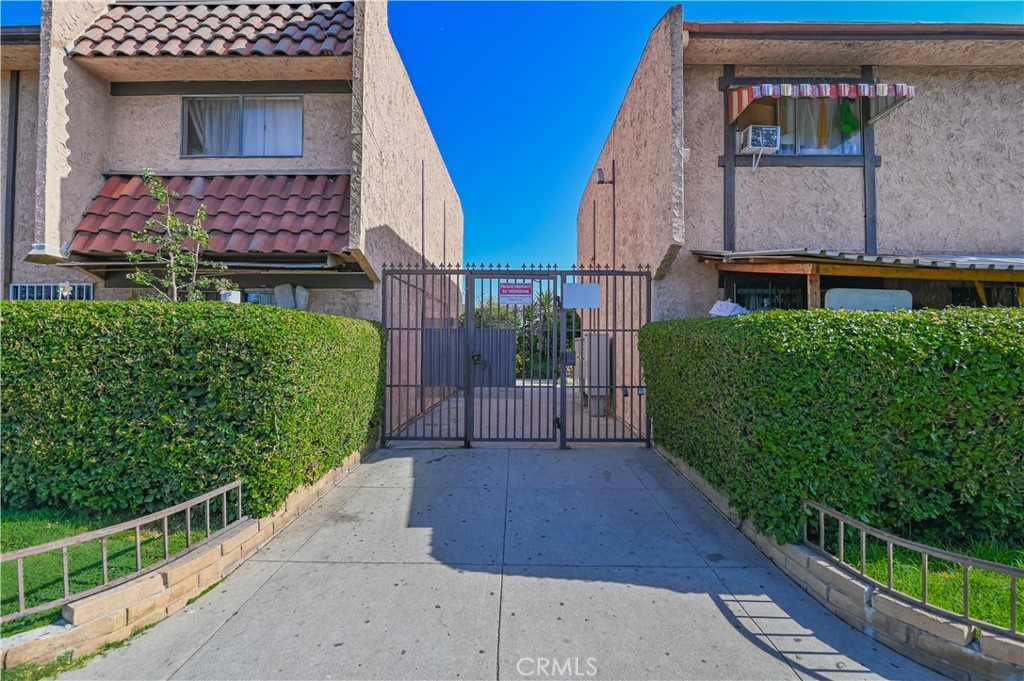 a view of a house with a small yard and potted plants