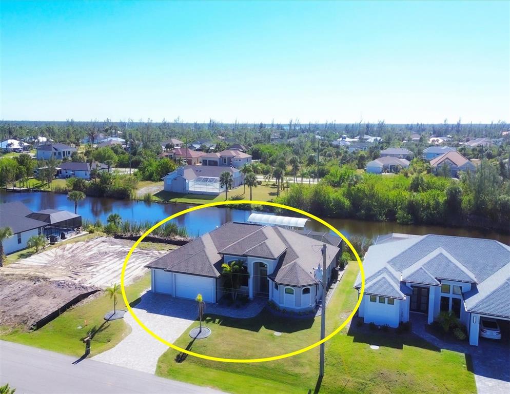 an aerial view of a house with swimming pool and big yard