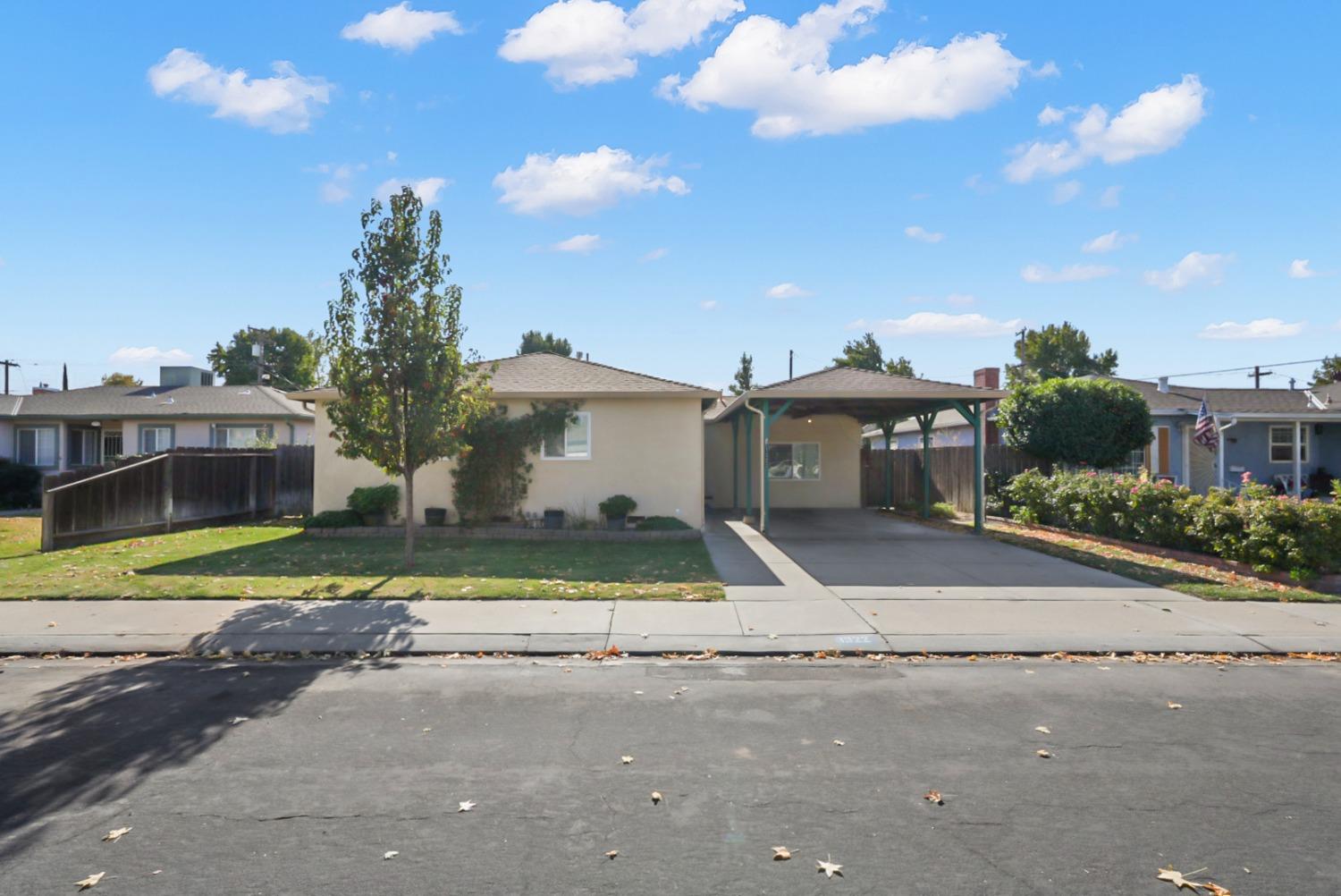 a view of a house with a street and a road