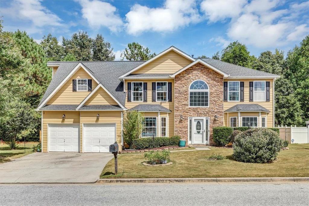 a front view of a house with a yard