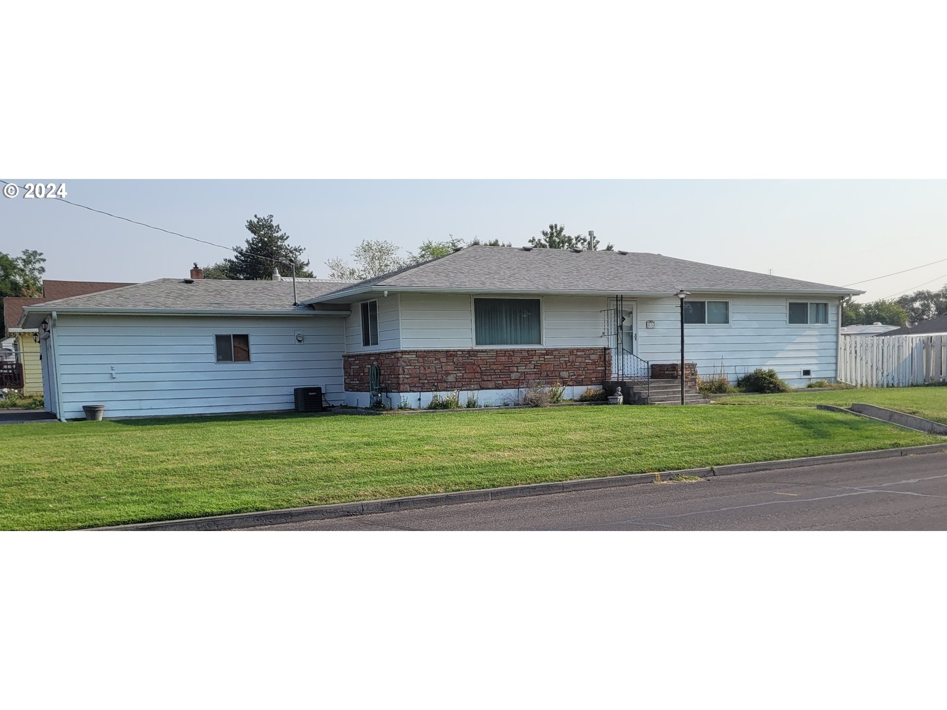 a front view of a house with a garden