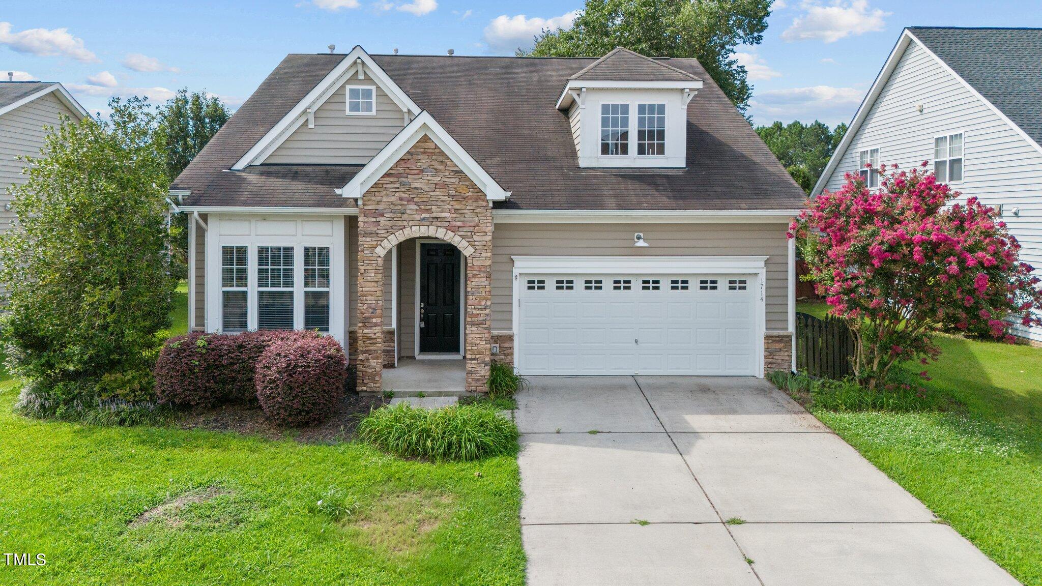 a front view of a house with a garden