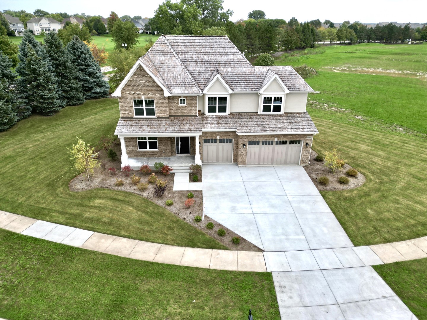 a view of house with garden space and swimming pool