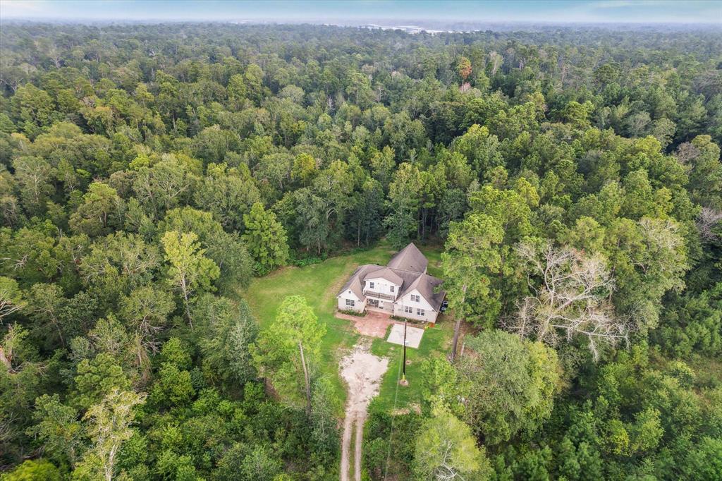 an aerial view of a house with a yard