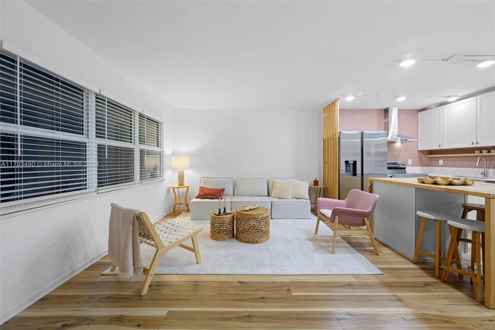 a living room with furniture and kitchen view