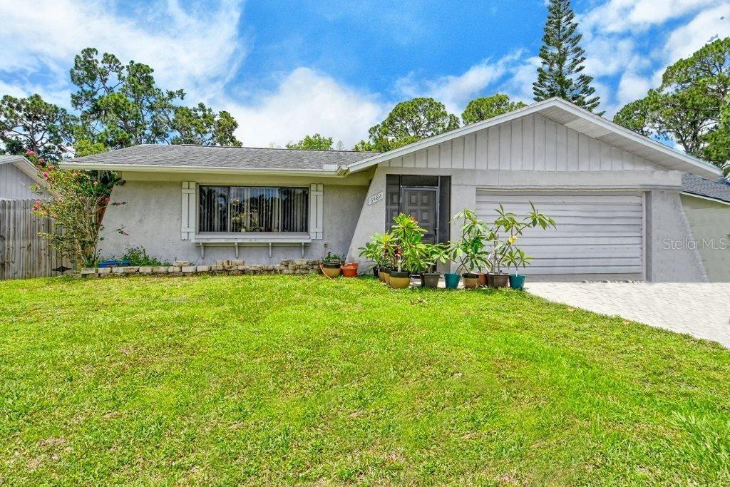 a front view of house with yard and green space