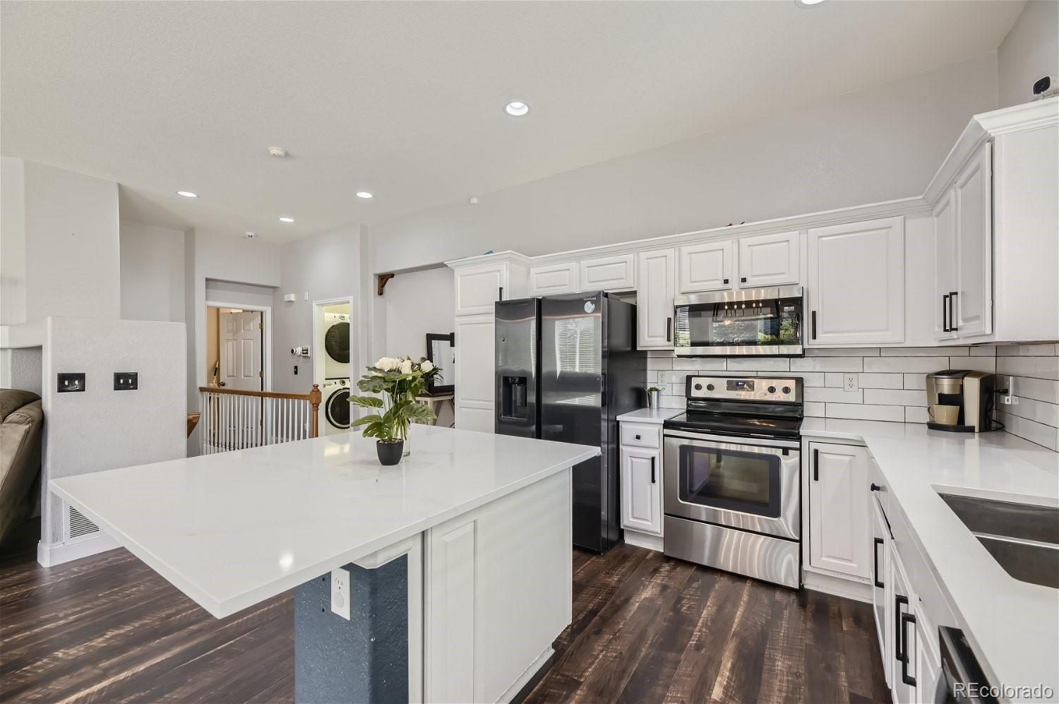 a kitchen with stainless steel appliances a stove sink microwave and cabinets