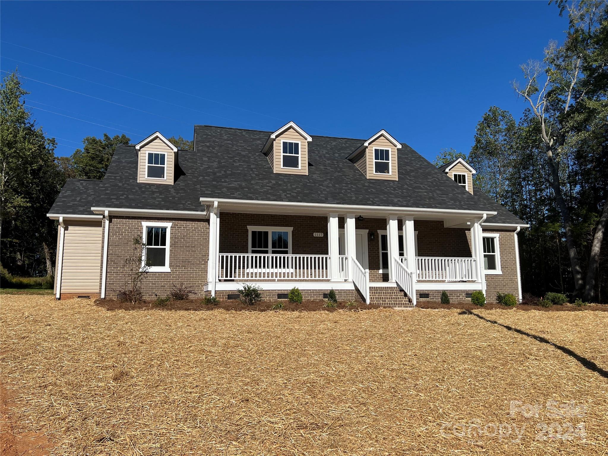 a front view of a house with yard