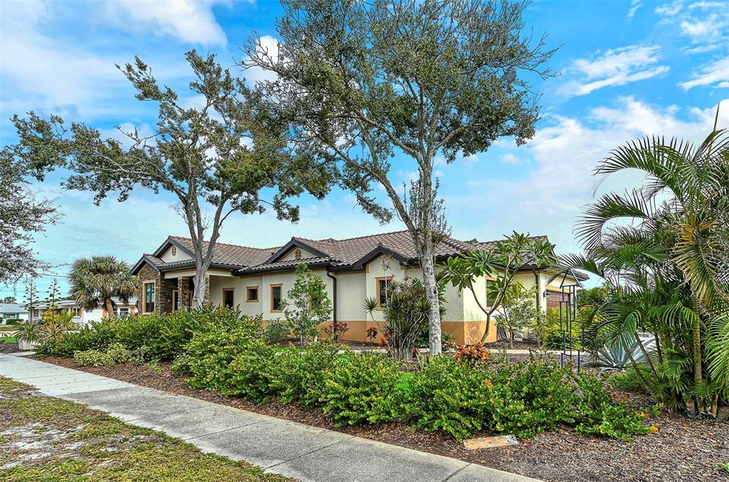 a front view of a house with a tree