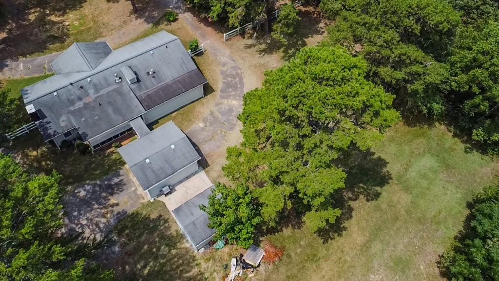 an aerial view of a house with a yard and garden