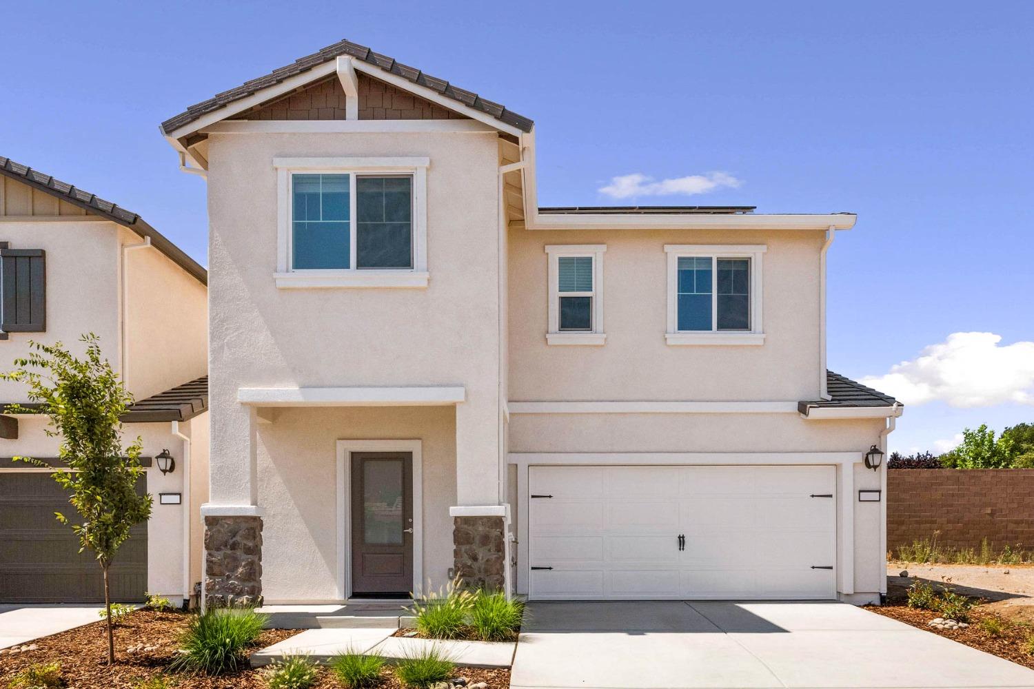 a front view of a house with garage