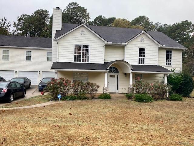 a front view of a house with a yard and garage