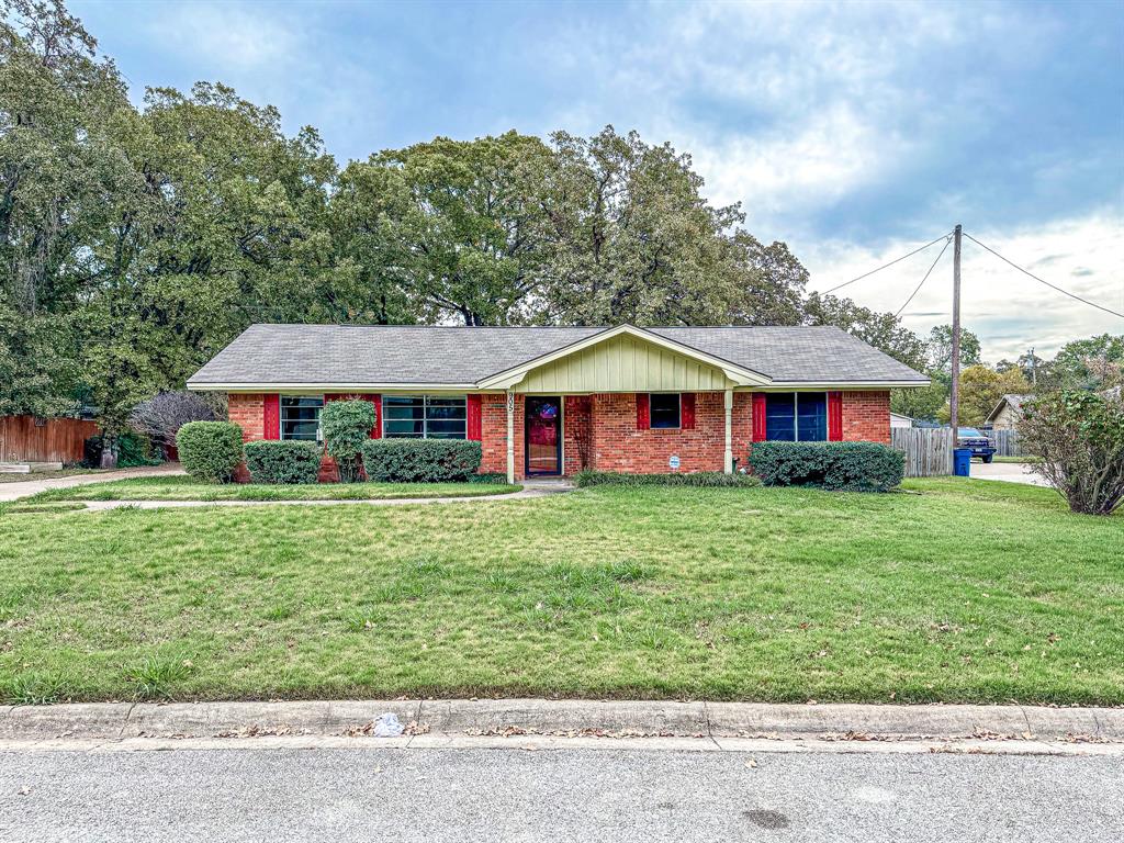 a front view of a house with a yard and porch