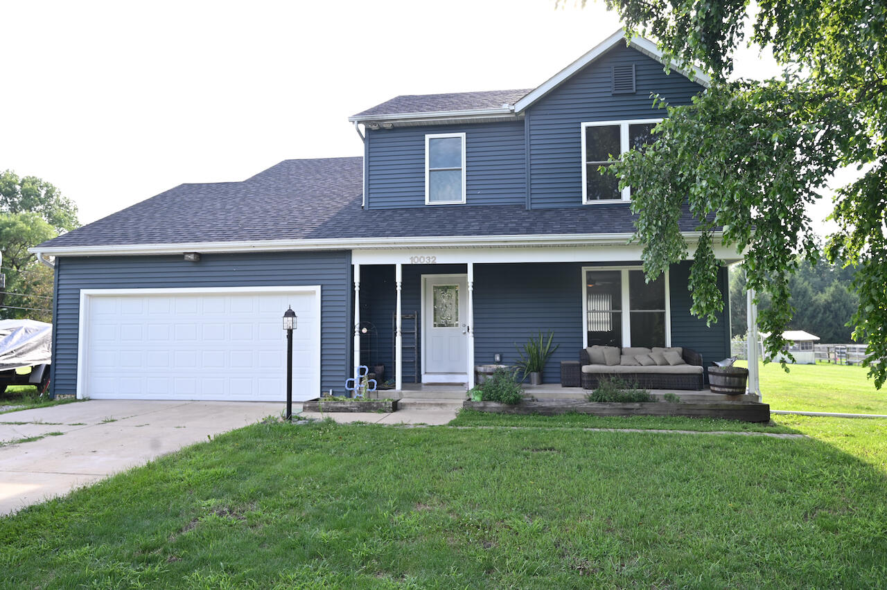 a front view of a house with a garden and yard