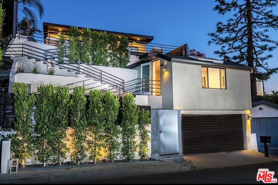 a front view of a house with garden