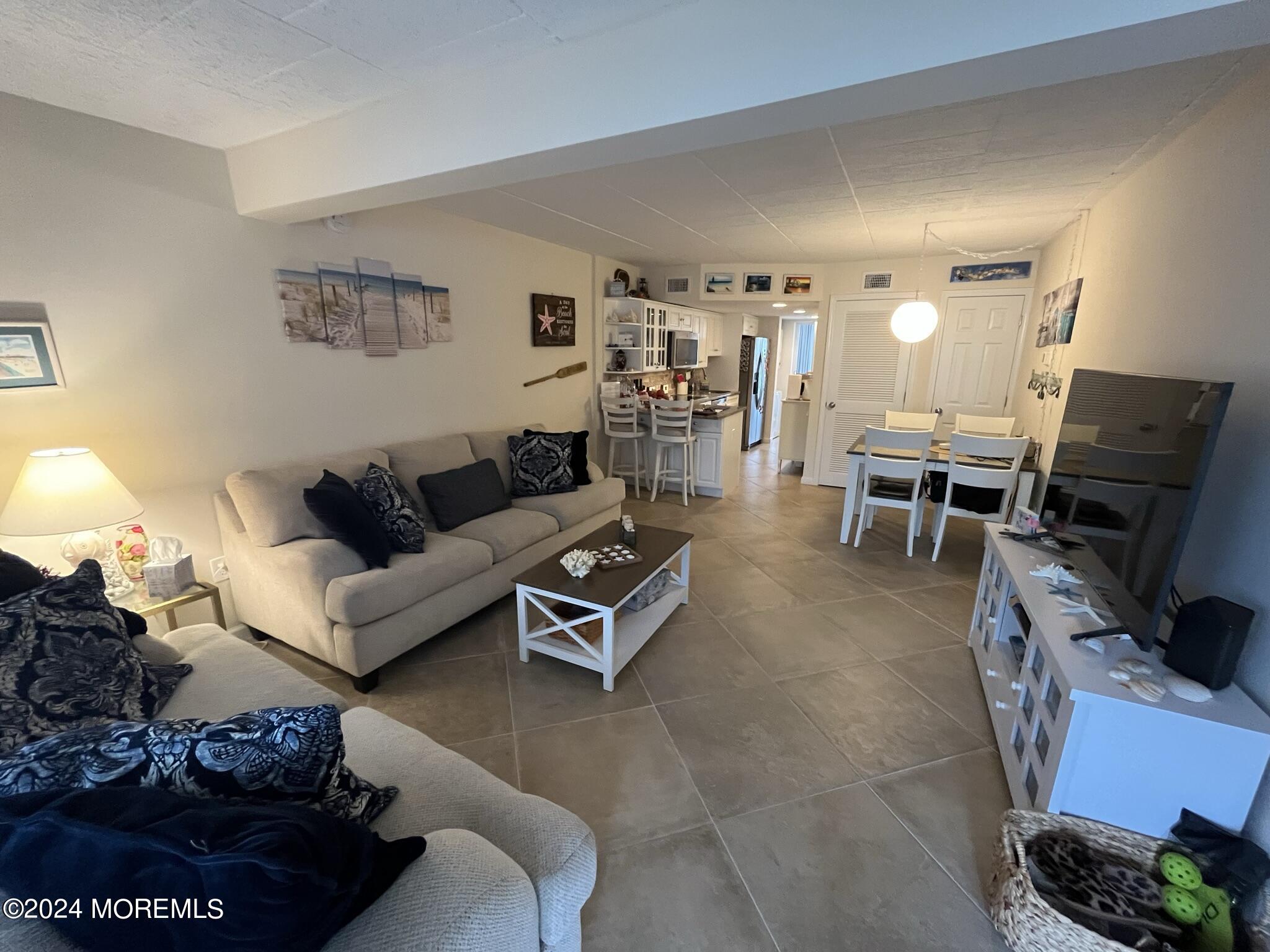 a living room with furniture a rug and a flat screen tv