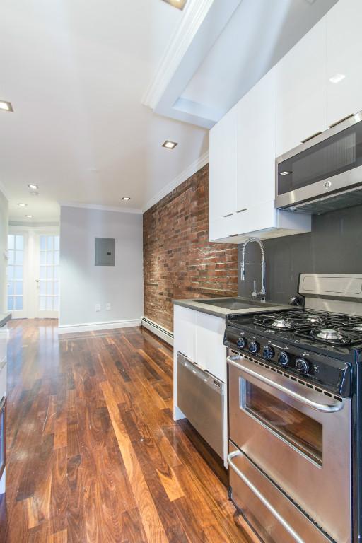 a kitchen with granite countertop a stove and a sink