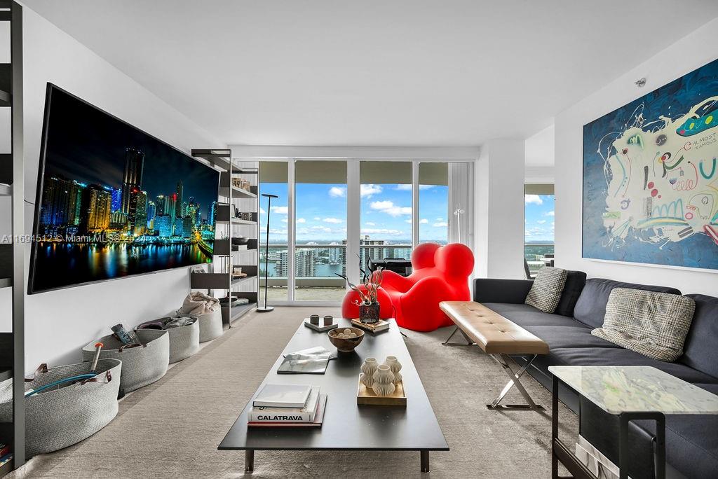 a living room with furniture fireplace and large window