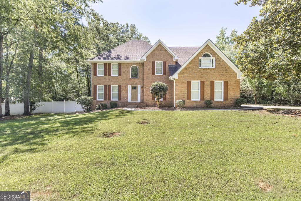 a front view of a house with a yard