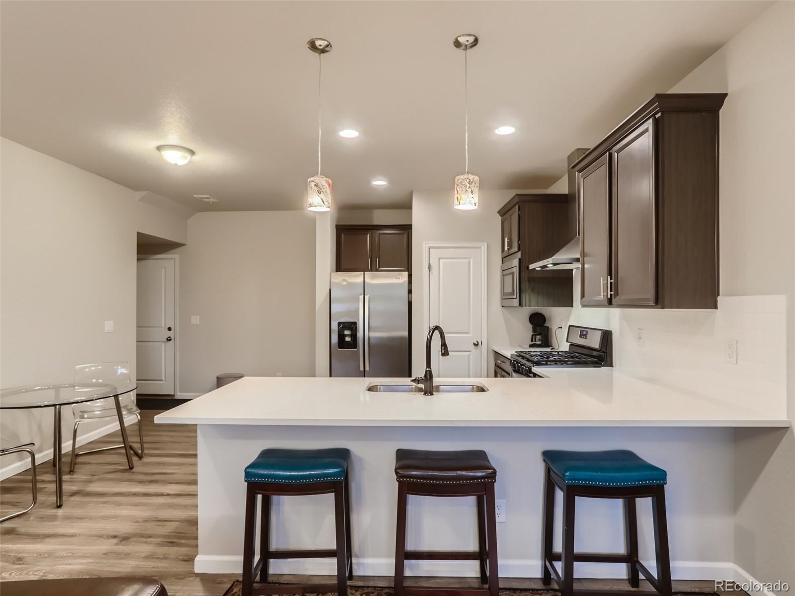 a kitchen with sink table and chairs