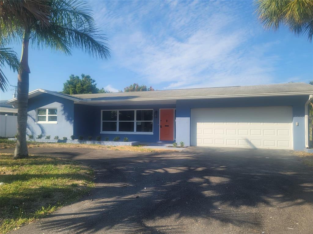 a front view of a house with a yard and a garage