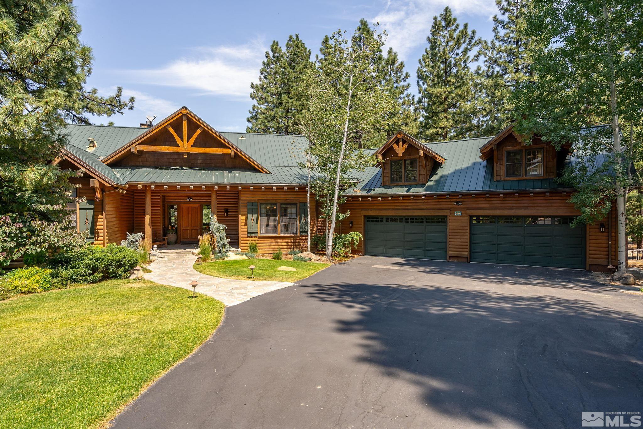 a front view of a house with yard and green space