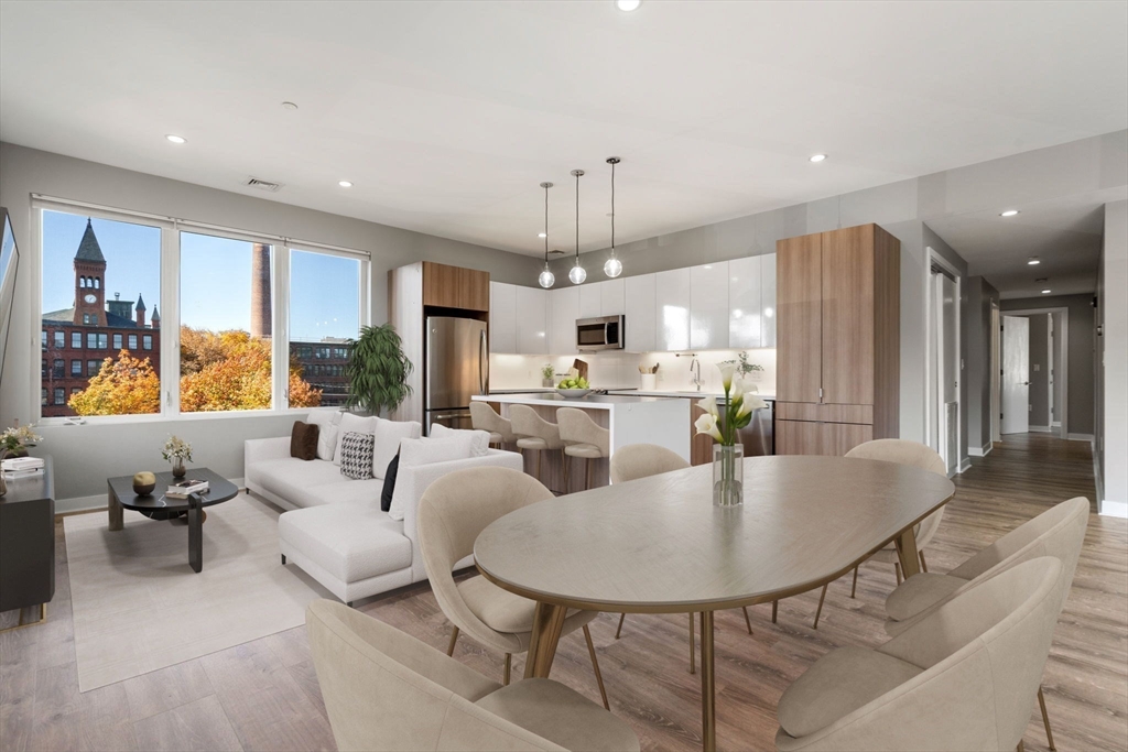 a living room with kitchen island furniture and a chandelier