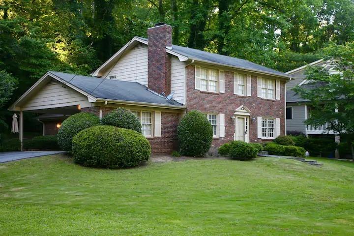 a front view of a house with a garden