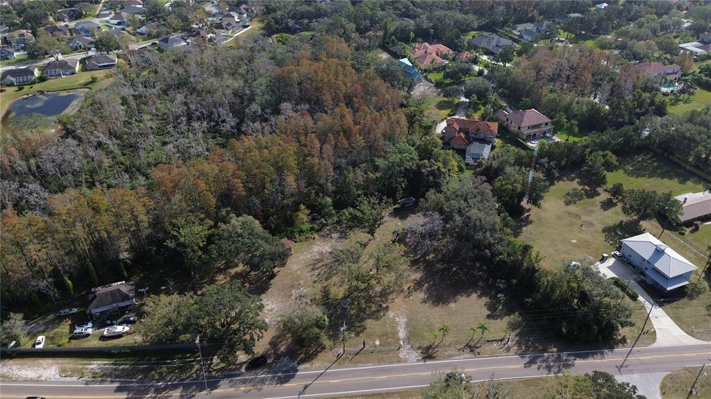 an aerial view of house with yard and mountain view in back