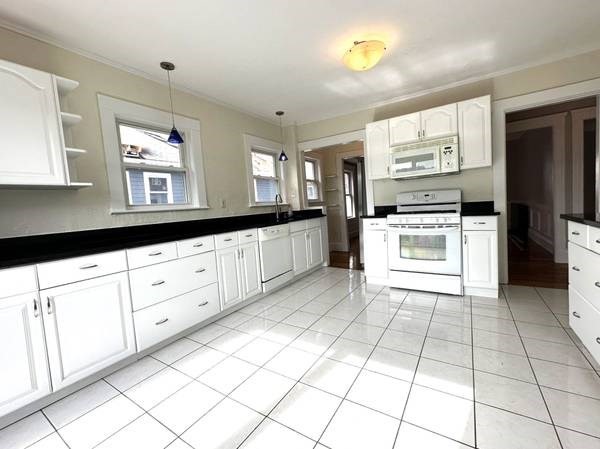 a kitchen with cabinets and appliances