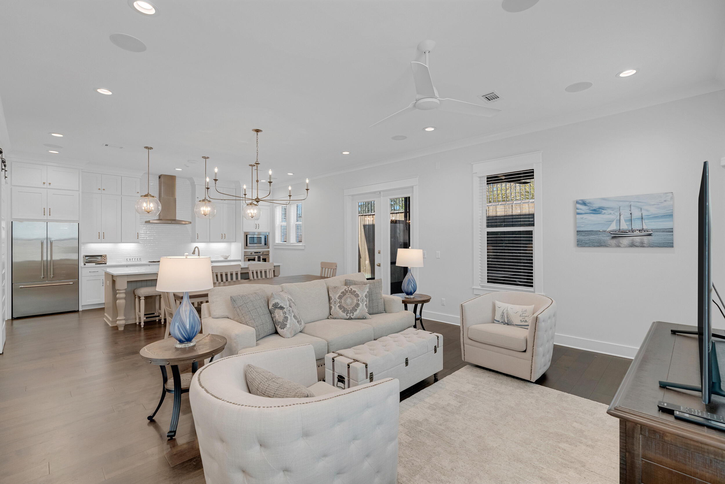 a living room with furniture and a chandelier