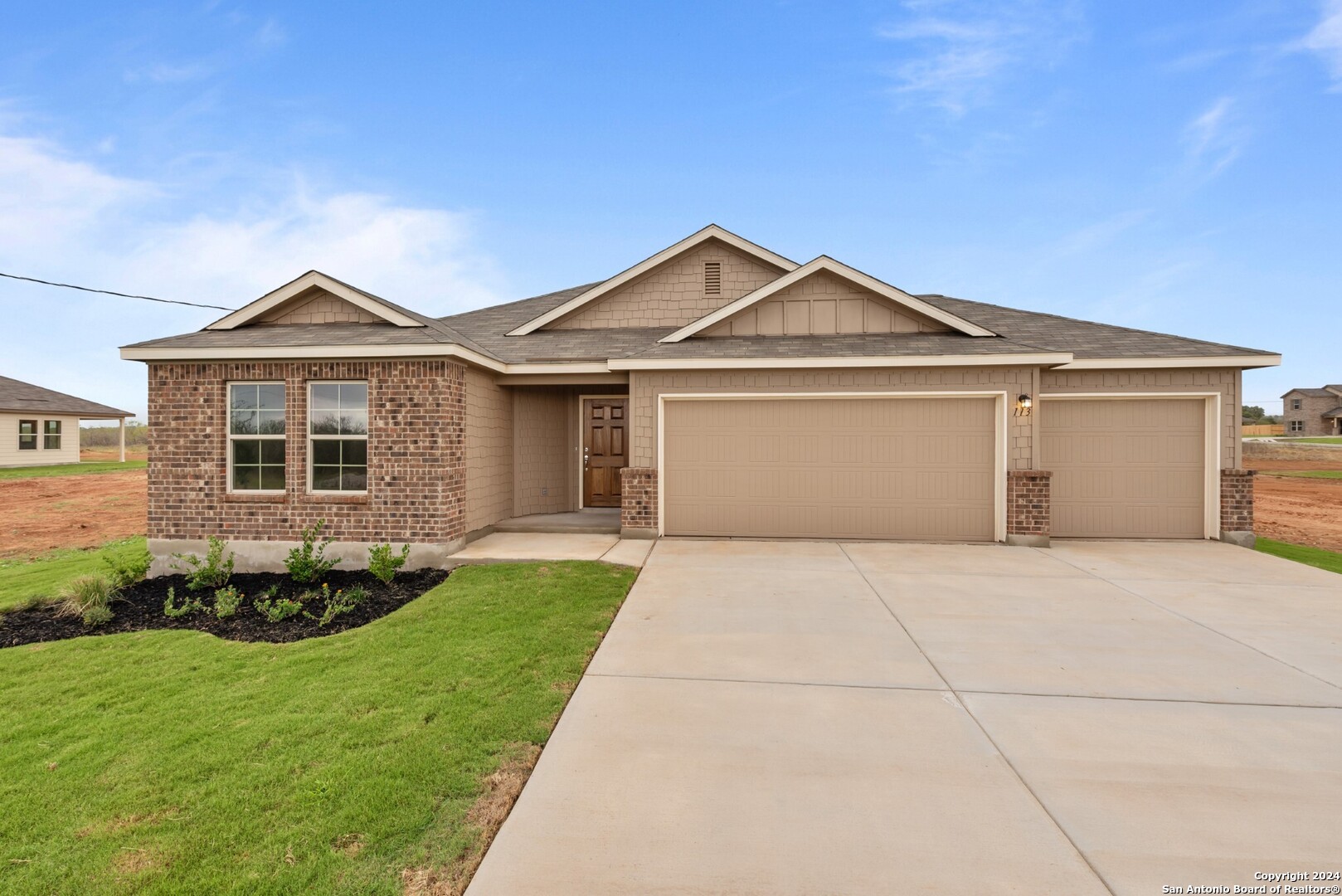 a front view of a house with a garden