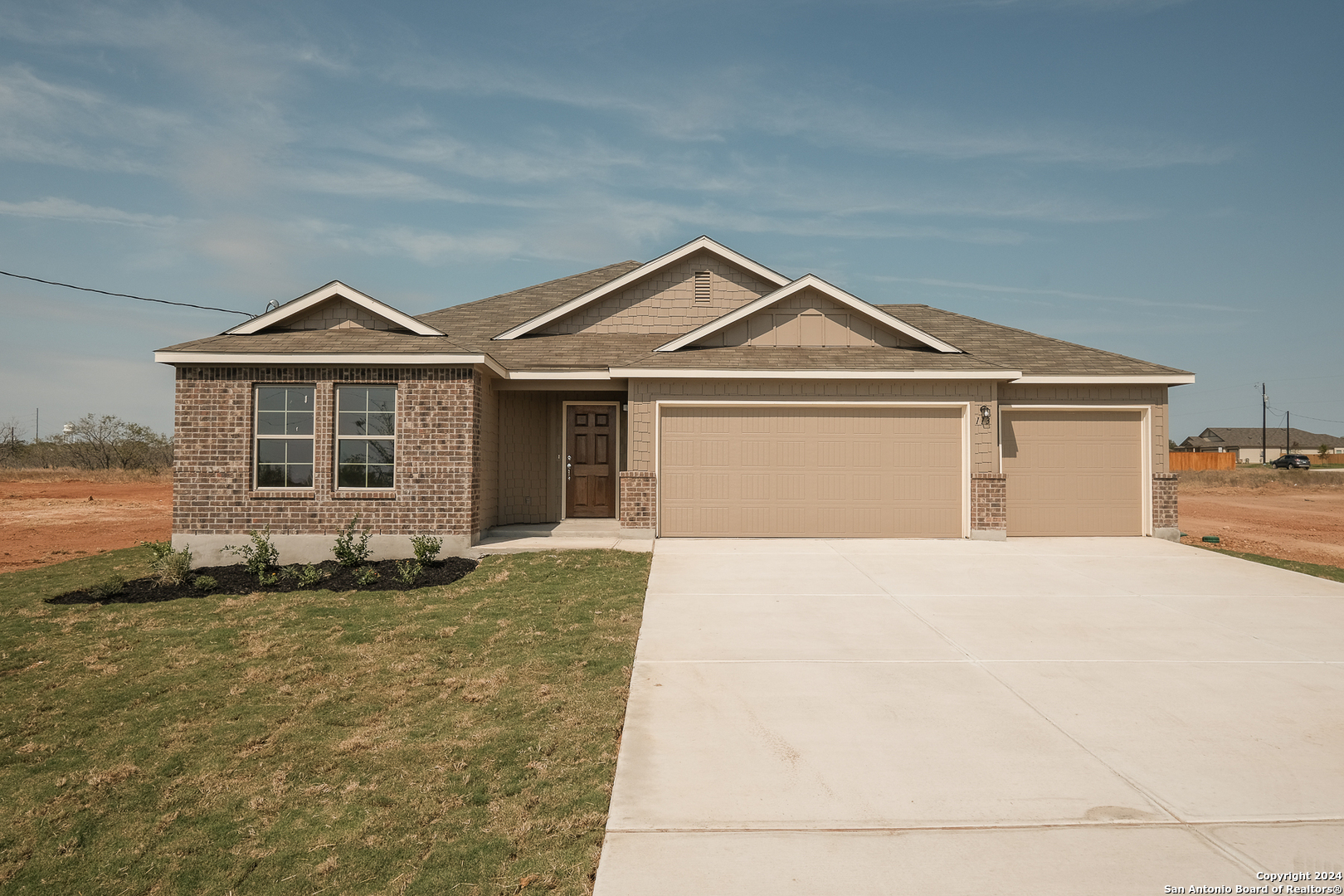 a front view of a house with a garden