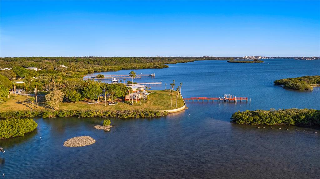 an aerial view of a ocean with residential houses with outdoor space