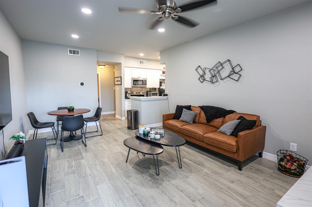 a living room with furniture and wooden floor