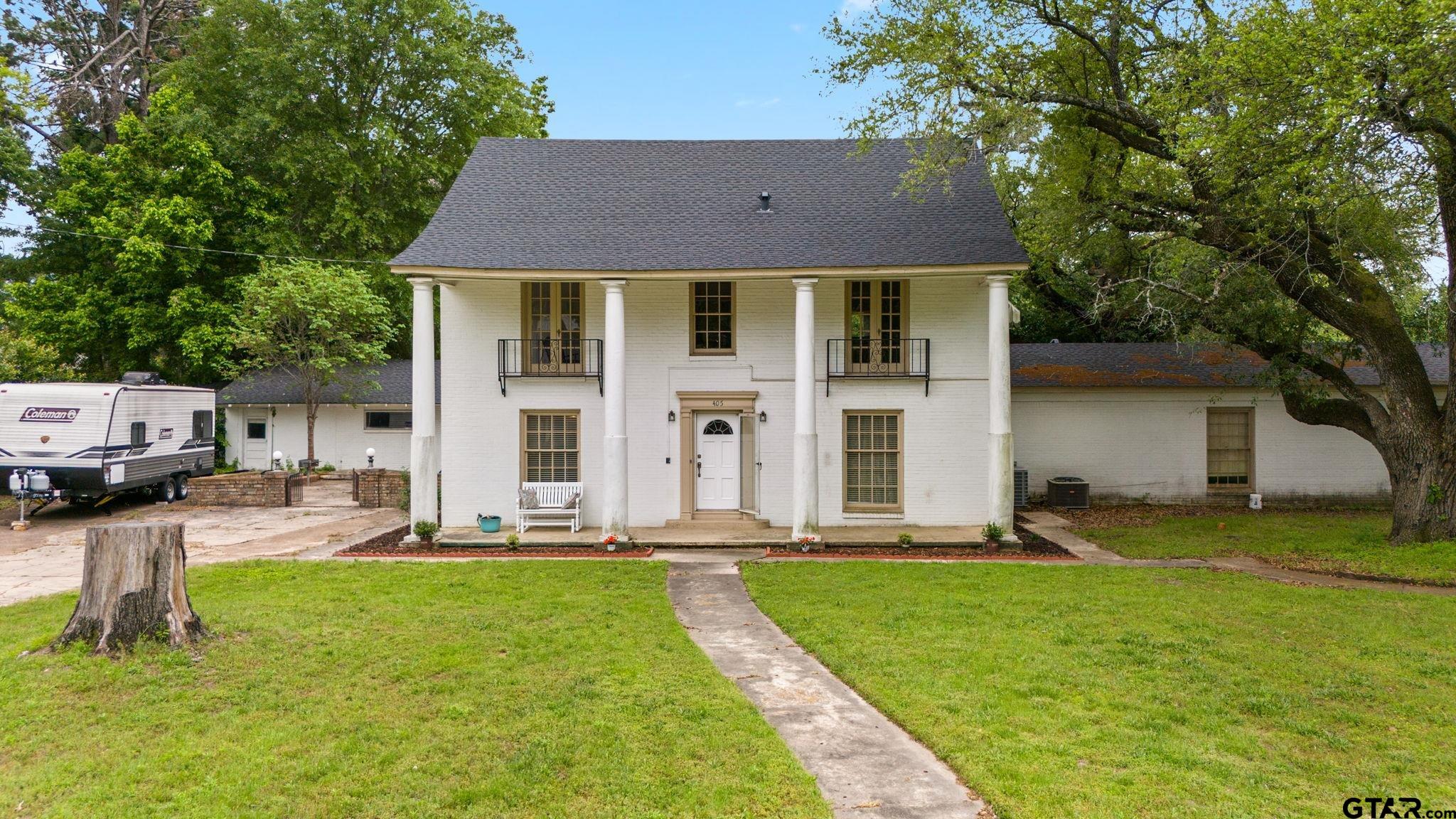 a front view of house with yard and green space