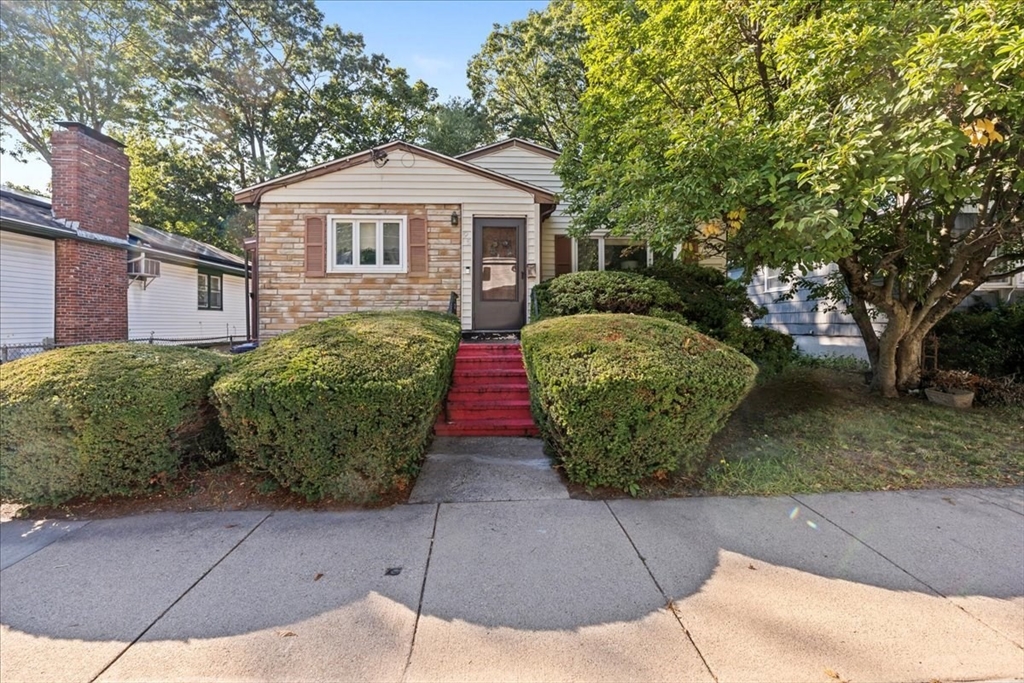 a front view of a house with garden