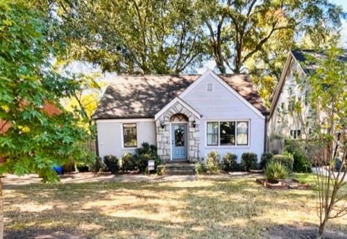 front view of a house with a trees and plants