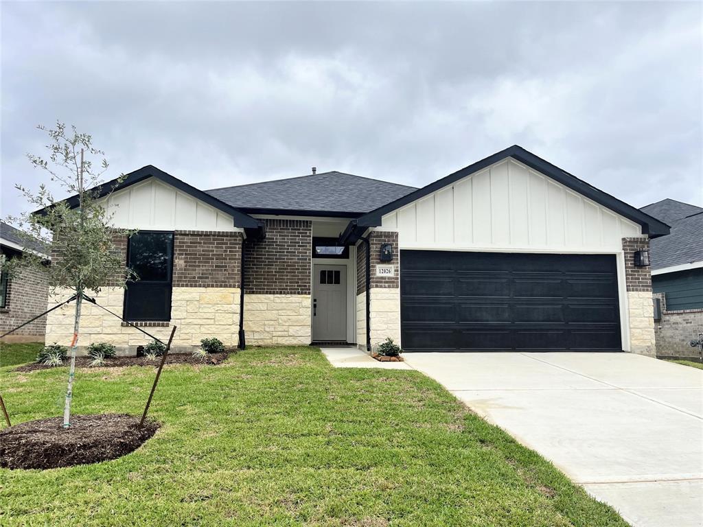 a front view of a house with a yard and garage