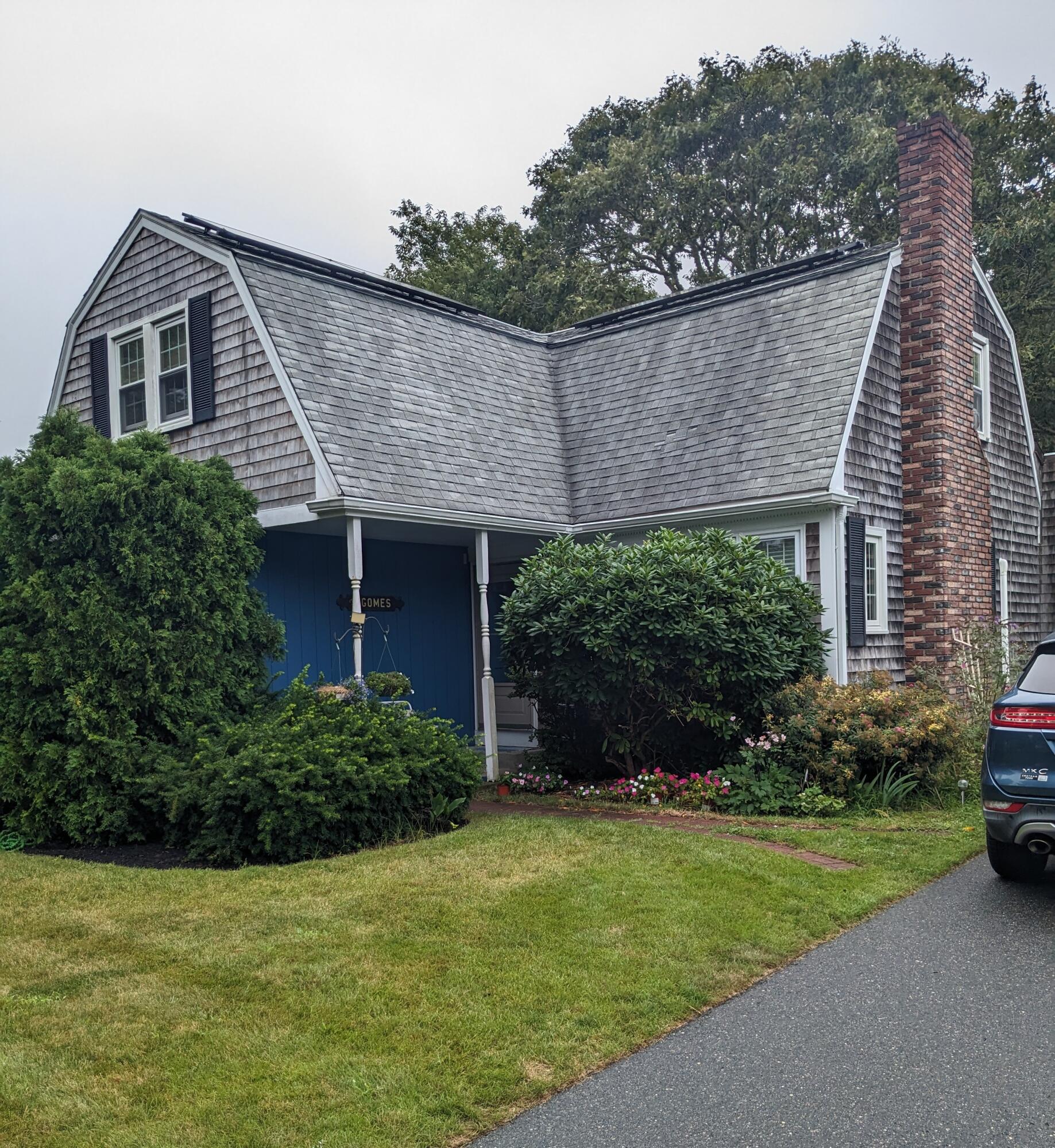 a front view of a house with a garden