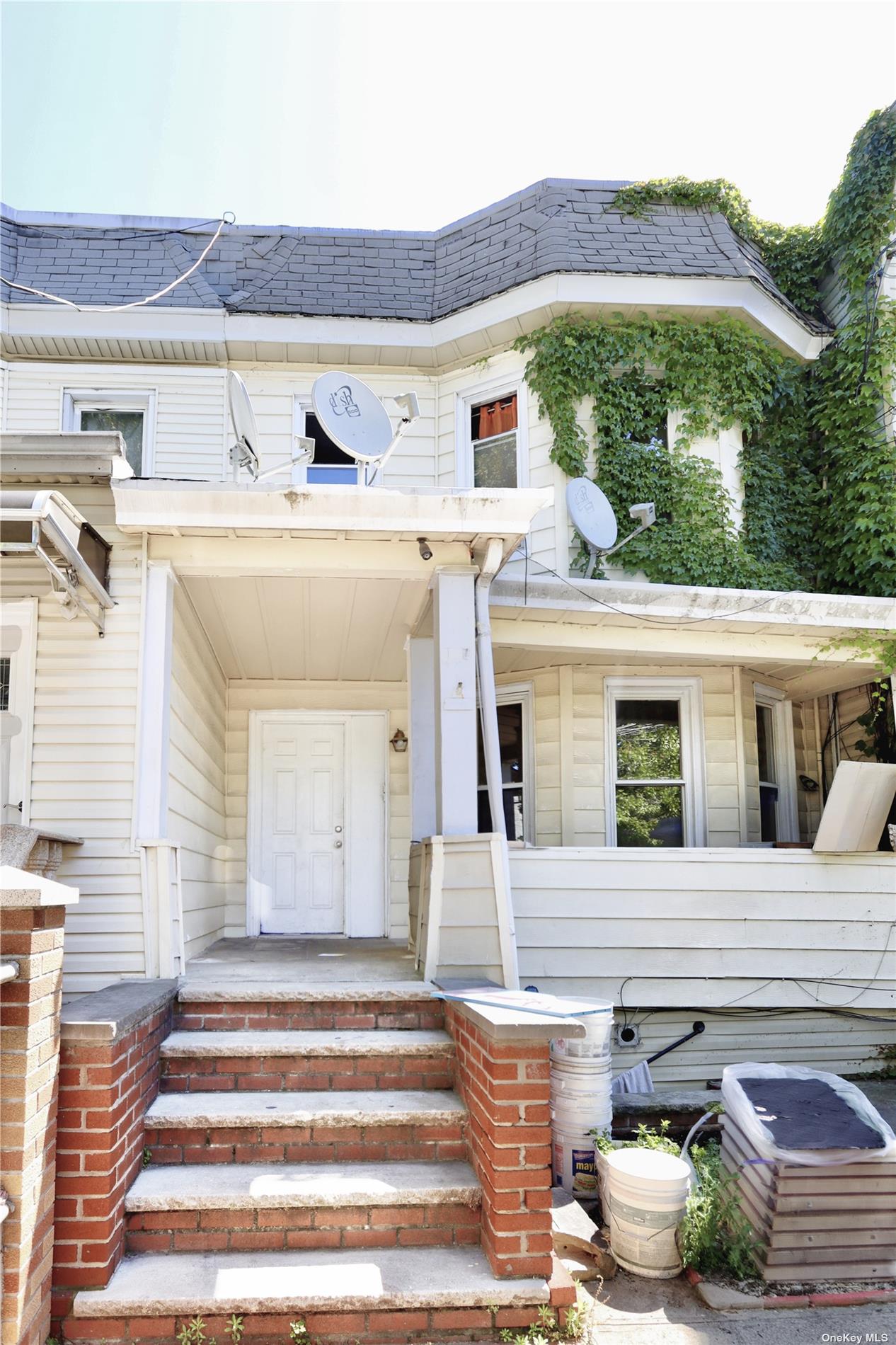 a view of a house with a patio and a yard