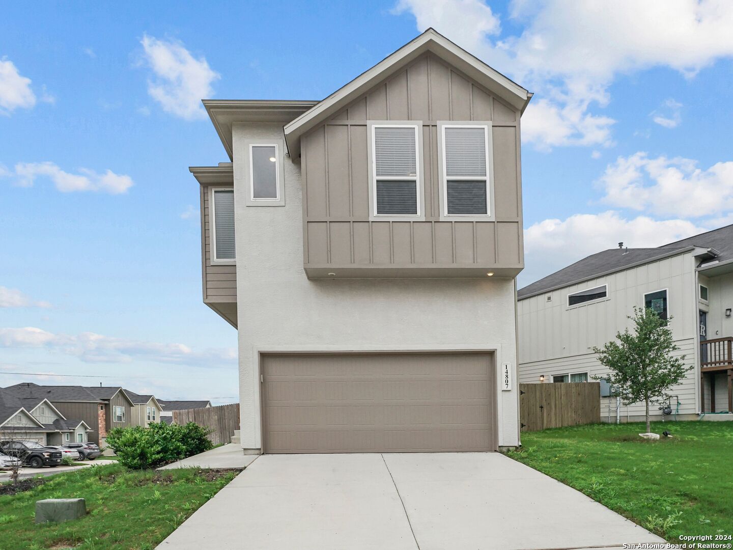 a front view of a house with a yard and garage