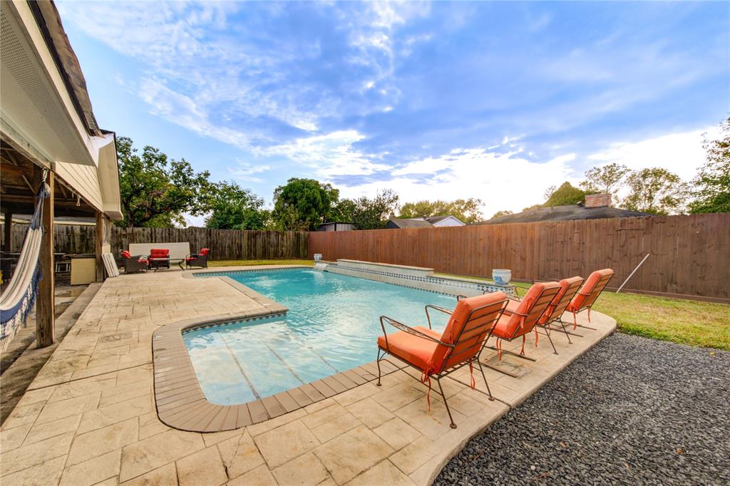 a view of swimming pool with lounge chair