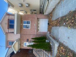 View of front of property with a garage and a balcony