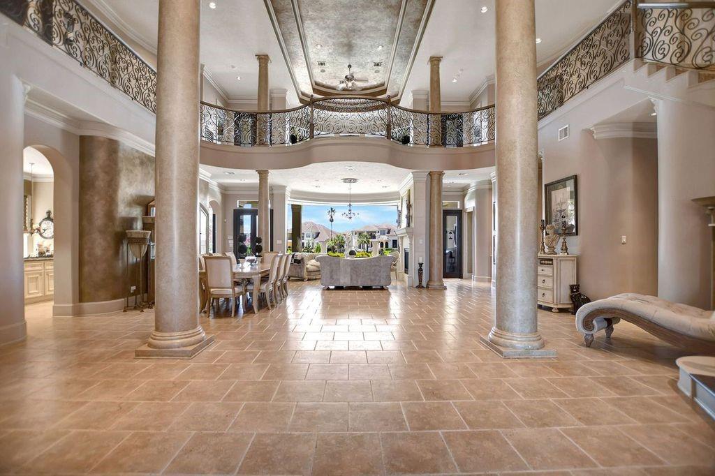 a lobby with furniture and a chandelier