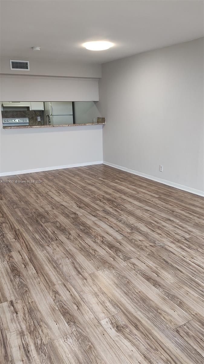 an empty room with wooden floor