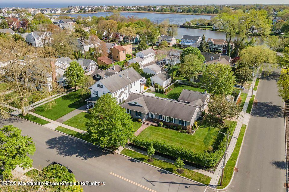 an aerial view of a house with a garden and lake view